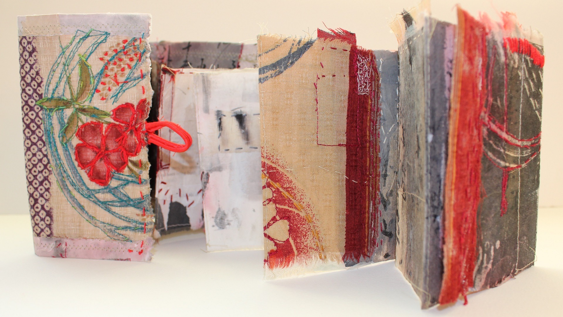 Textile art folded book with collage and embroidery