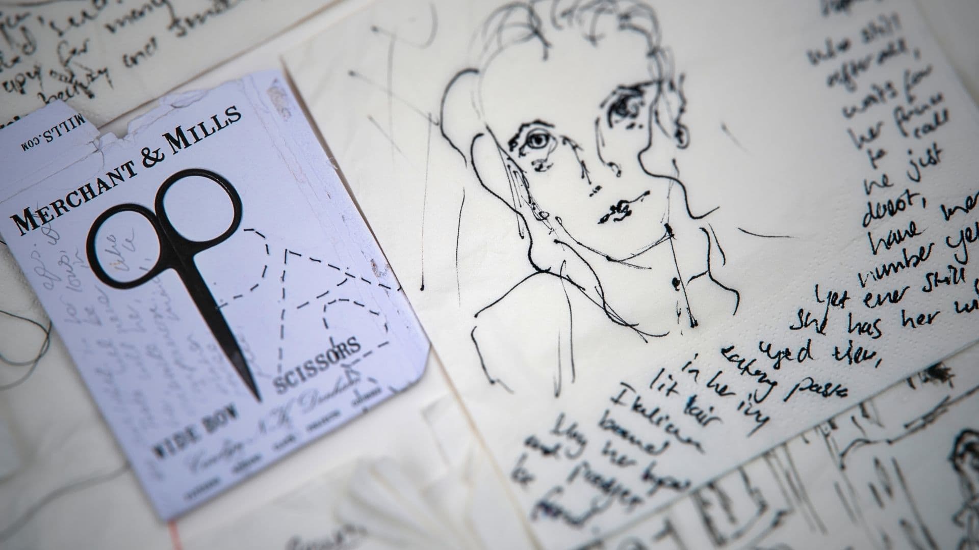 A close up ink drawing of a woman with scissors and a piece of paper