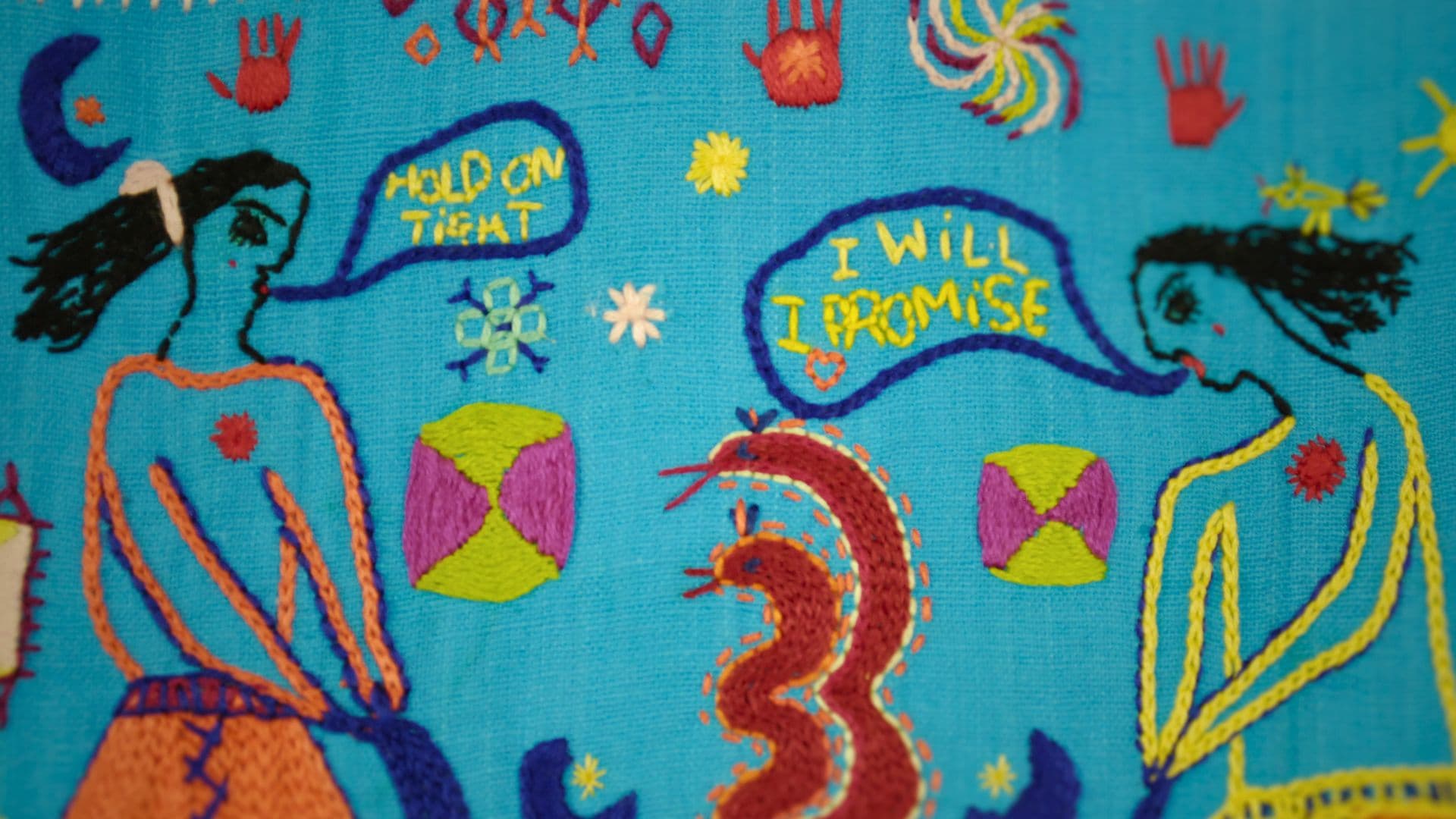 Stitched textile art with 2 embroidered characters talking